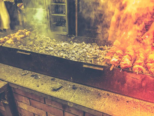 istock Marinated shashlik preparing on a barbecue grill over charcoal. Roasted stacked meat Shish kebab popular in Goergia. Traditional cuisine in Georgia 987893108
