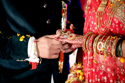 Bride and groom hands holding bridal showing wedding Jewelry Ring & Bangles
