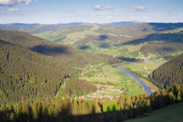 istock landscape with Bistrita river and countryside scene 987900426