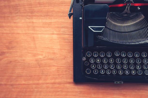 istock Vintage typewriter machine on writers desk 987920096