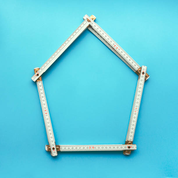 istock Wood carpenter folding ruler in shape of a house 987920458