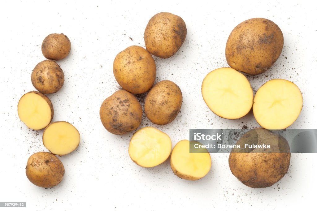 Fresh Organic Potatoes Isolated on White Background Fresh organic potatoes isolated on white background. Top view Raw Potato Stock Photo