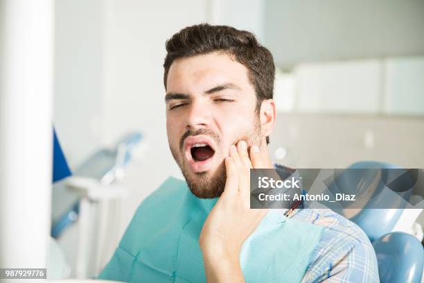 Male Patient Suffering From Toothache In Dental Clinic Stock Photo - Download Image Now