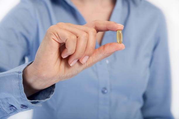 istock Woman holds pill 987929840