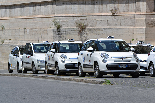 Rome, Italy - 31 May, 2018: Fiat taxi vehicles waiting for the passengers on the street in Rome. On the first plan we see the Fiat 500L model. The Fiat cars are the most popular vehicles in Italy.