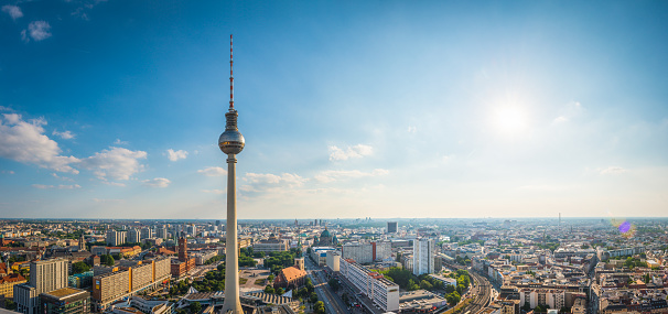 Summer sunlight flaring over the rooftops of central Berlin overlooked by the iconic spire of Fernsehturm, Alexanderplatz, in the heart of Berlin, Germany’s vibrant capital city.