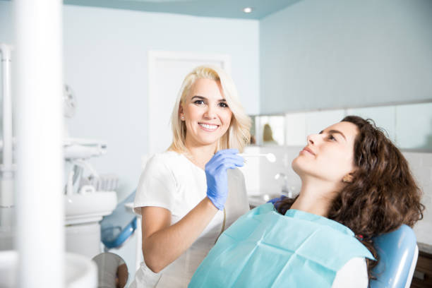 istock Attractive dentist working in a clinic 987937280