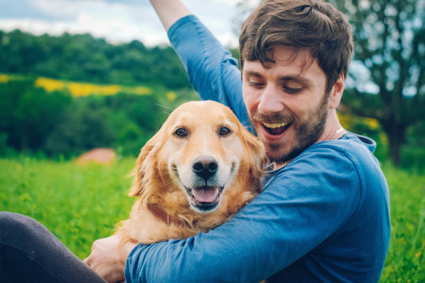 istock Guy and his dog, golden retriever, nature 987946914