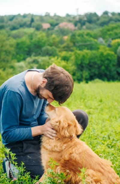 istock Guy and his dog, golden retriever, nature 987947068