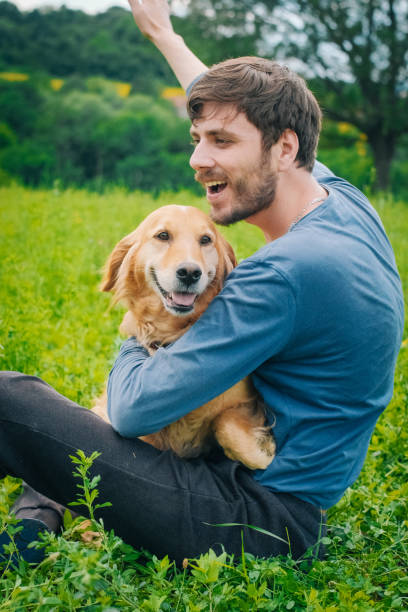 istock Guy and his dog, golden retriever, nature 987956664