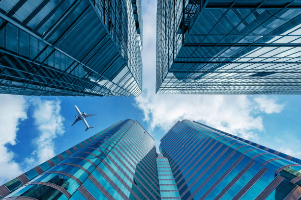 Exterior of the office buildings. Exterior of the office buildings and plane in the sky. kowloon stock pictures, royalty-free photos & images