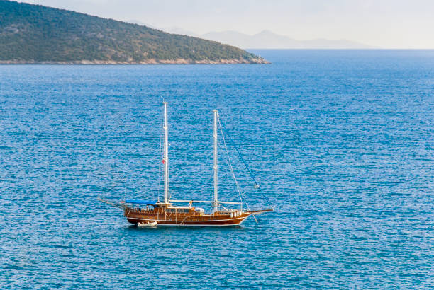 Bodrum, Turkey, 18 May 2010: Bodrum is a district and a port city in Mugla Province, in the southwestern Aegean Region of Turkey. It is located on the southern coast of Bodrum Peninsula and is also the center of the eponymous district. The city was called Halicarnassus of Caria in ancient times and was famous for housing the Mausoleum of Mausolus, one of the Seven Wonders of the Ancient World. Built by the Knights Hospitaller in the 15th century, Bodrum Castle overlooks the harbour and the marina. The castle includes a museum of underwater archaeology and hosts several cultural festivals throughout the year.