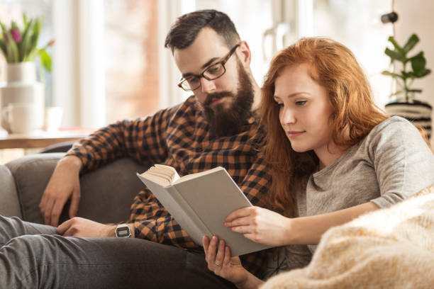 istock Lovely couple rading book 987982710