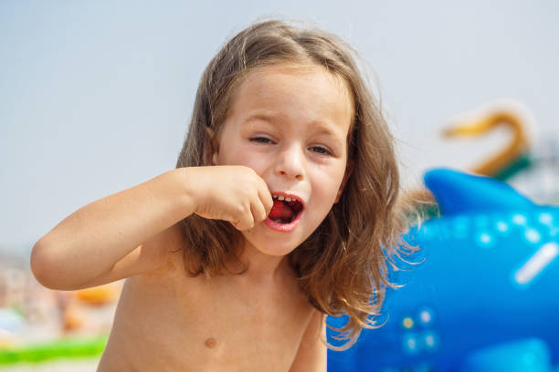 istock Beautiful boy is eating raspberries 987987008