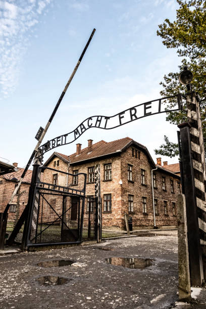 Arbeit macht frei sign in Auschwitz I concentration camp, Oswiecim, Poland AUSCHWITZ, POLAND - AUGUST 27, 2017. Arbeit macht frei sign on the main entrance gateway to Auschwitz-Birkenau (Auschwitz I) concentration camp near Oswiecim city, Poland ethnic cleansing stock pictures, royalty-free photos & images