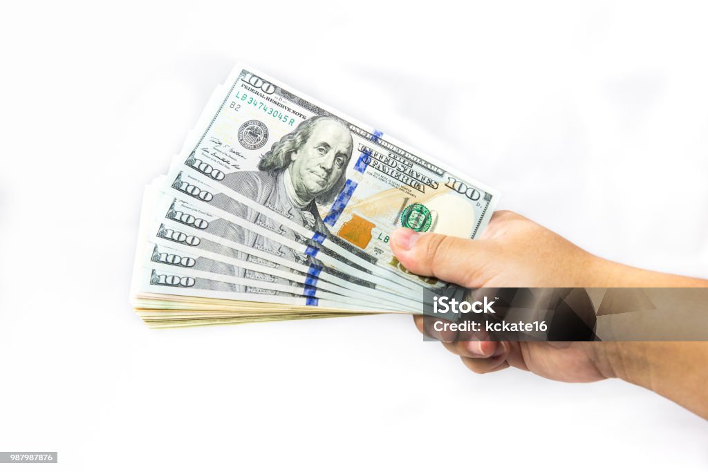 Dollor Money in hand, isolated on white background. dollar currency of USA. american banknotes. Dollor Money in hand, isolated on white background. dollar currency of USA. american banknotes. currency scattered in hand. Money hundred dollars.US currency banknotes. Many dollor banknote. Revenue Stock Photo