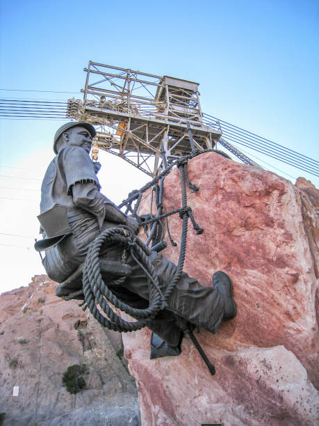 View from below of a sculpture in memory of those who built the Hoover Dam in Nevada during day View from below of a sculpture in memory of those who built the Hoover Dam in Nevada during day hoover dam statues stock pictures, royalty-free photos & images
