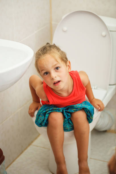 istock Boy sitting on the toilet 987998330