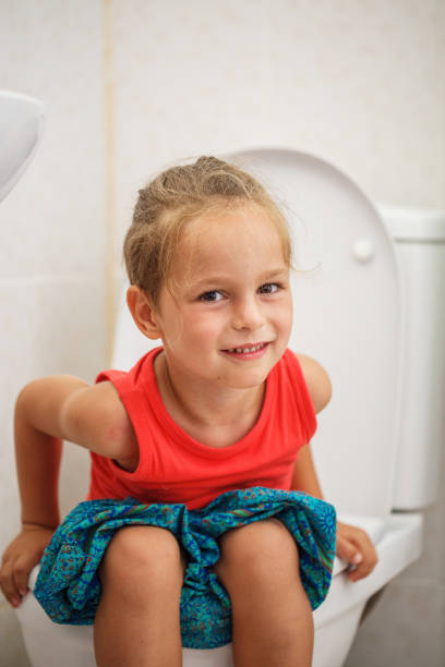istock Boy sitting on the toilet 987998432