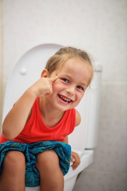 istock Boy sitting on the toilet 987998584