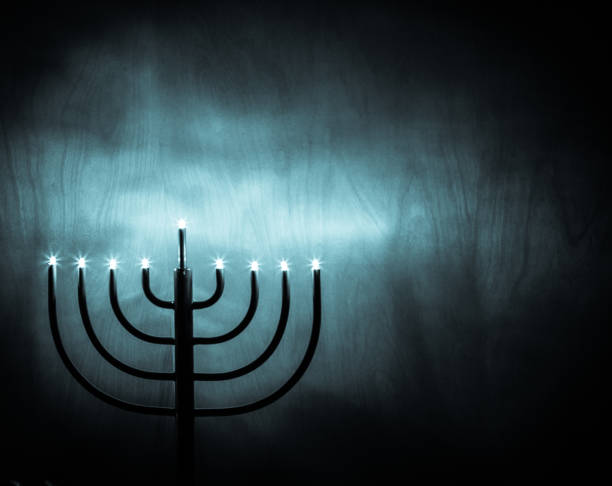 Hanukkah Menorah lighting up a wooden wall, blue monochrome, high contrast, deep shadows