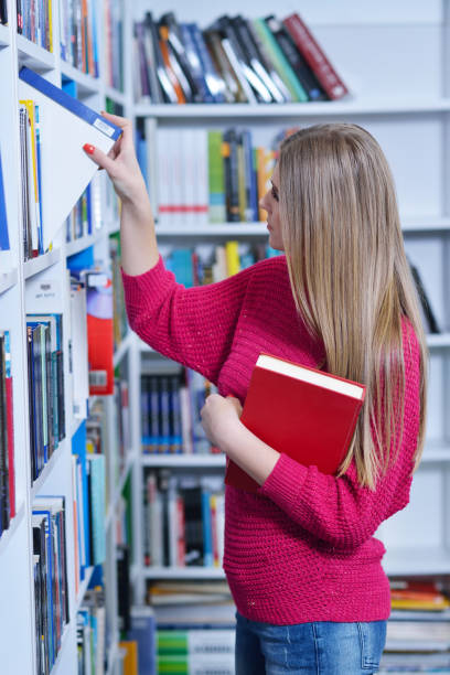 istock Beautiful female student in a university library 988013718