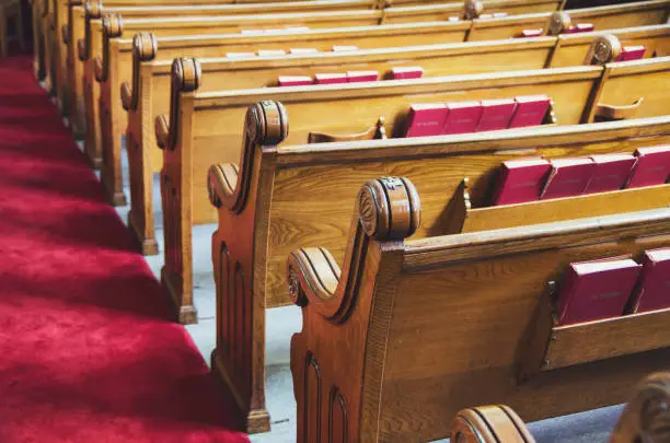 Large old wooden church pews and aisle