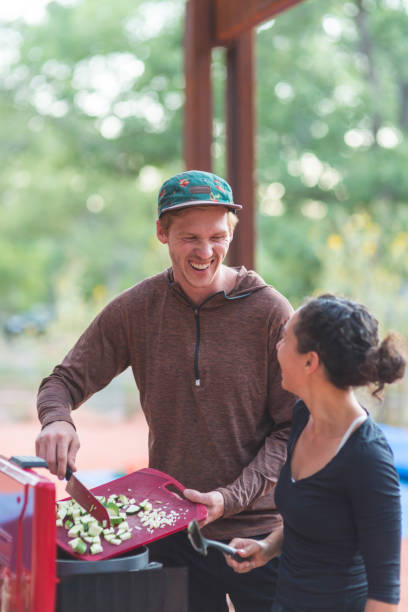istock Two friends cook food on a camping trip 988063382