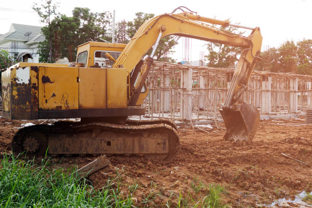 istock The dirty old excavator on building site in sunlight. 988086252