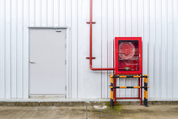 istock Fire safety equipment in the red box on metal sheet pattern 988093354
