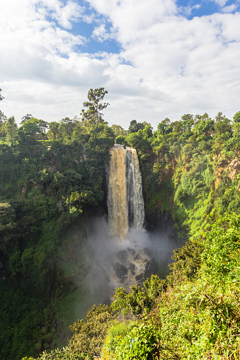Landscape with a waterfall and clouds. Thompson Waterfall. Kenya, Africa