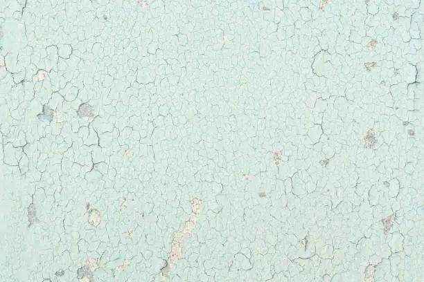 Closeup surface of pale color and peeling of painted green cement wall texture background
