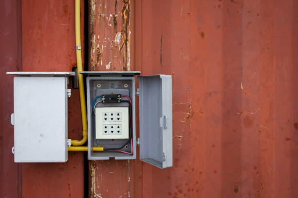 istock Electrical installation of outdoor cables on old cargo container. 988116308