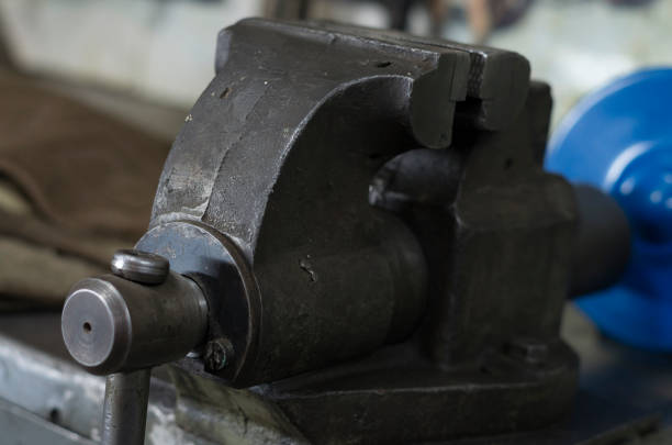 istock Vise tool on wooden top surface. Vise on workbench. Tool for metalworking. Engineer or blacksmith and industry instrument. Fixing and squeezing. 988117260