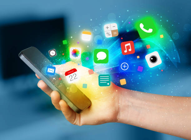 istock Hand holding smartphone with colorful app icons 988138706