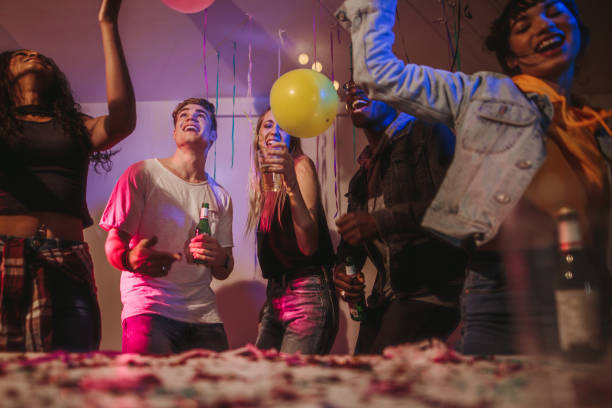 istock Friends dancing at a house party 988139440