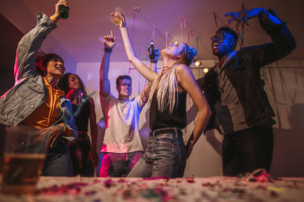 istock Friends dancing at a house party 988139646