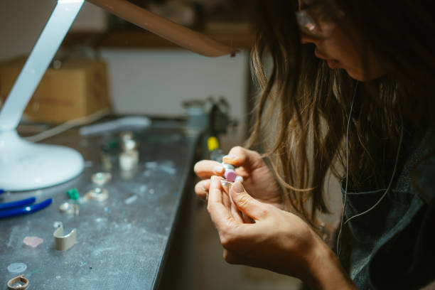 istock girl master processes the metal plate in the home workshop 988144294