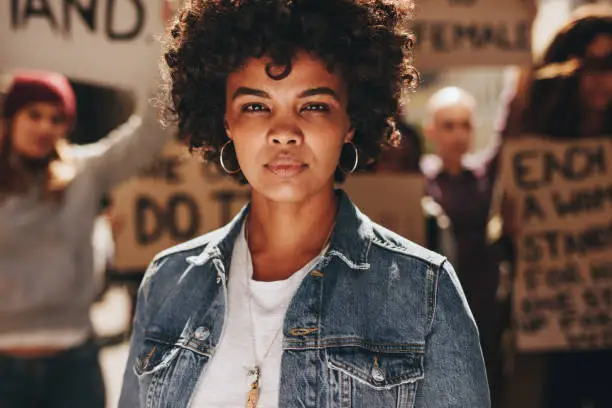 Photo of Woman activist protesting outdoors with group