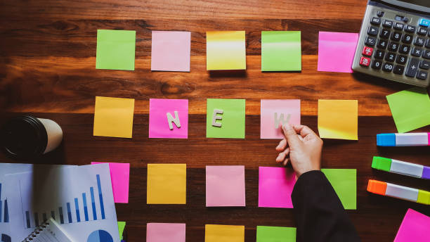 New. Business man in black suit meeting at home office and using notes paper  share design planning. brainstorming brainstorm idea on desktop wood table Top view