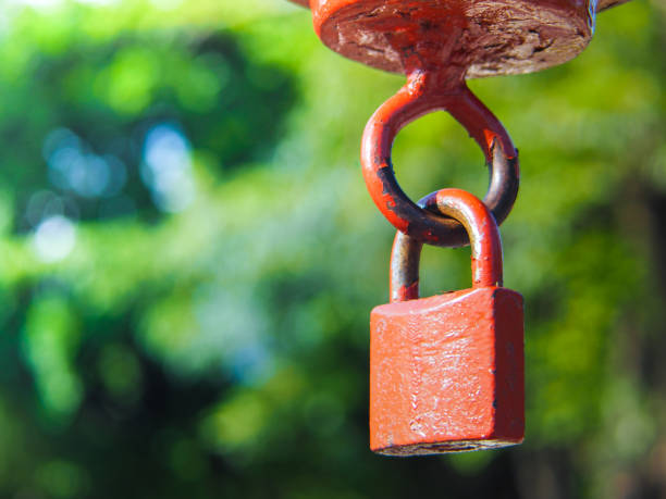 istock Old rusted red lock with space for place your text. 988186808