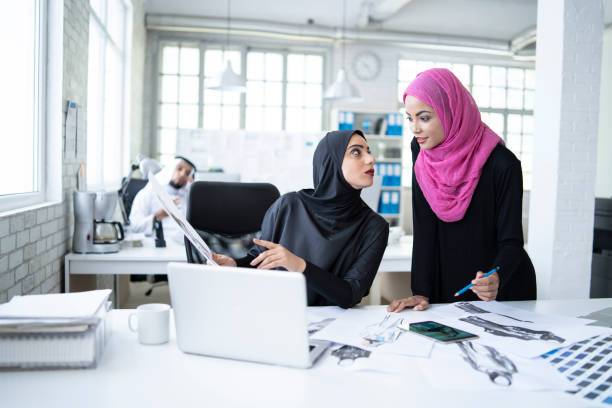 istock Female fasion designers discussing new models 988188538