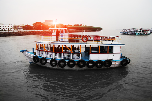 A ferry is a merchant vessel used to carry passengers, and sometimes vehicles and cargo as well, across a body of water. Ferries form a part of the public transport systems of many waterside cities and islands, allowing direct transit between points at a capital cost much lower than bridges or tunnels.