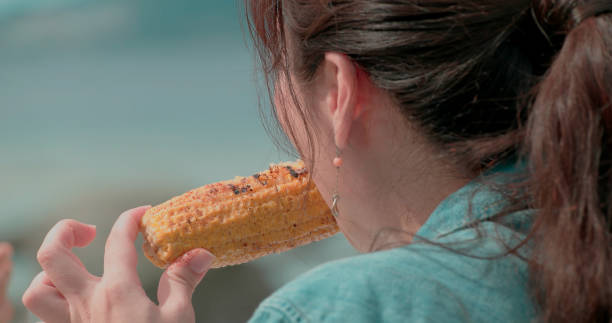 Young people prepare for eat and drink outdoors.