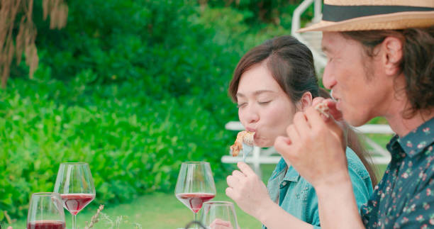istock Young people eating outdoors. 988192026