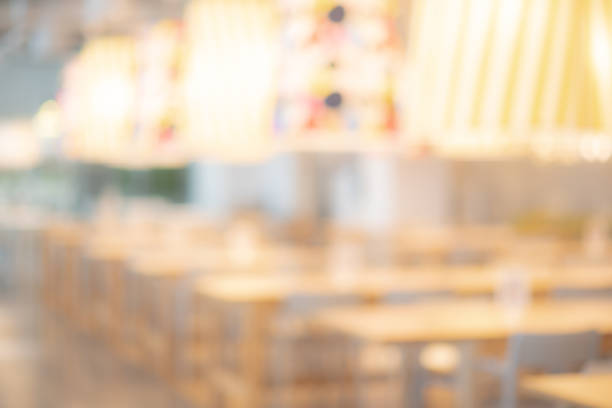 istock Abstract blurred restaurant background. Blurry cafe or coffee shop with dining tables, chairs and other decorations. Blur backdrop for design element. Food and beverage concept. 988197464