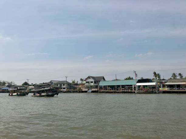 istock Fisherman village along the river in Thailand 988198100