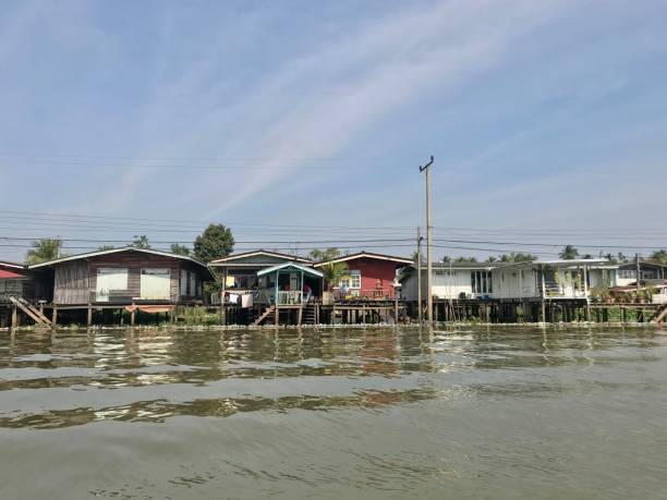 istock Fisherman village along the river in Thailand 988198238