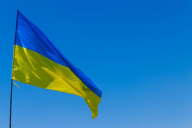 istock Blue-yellow flag of Ukraine on blue sky background 988198380