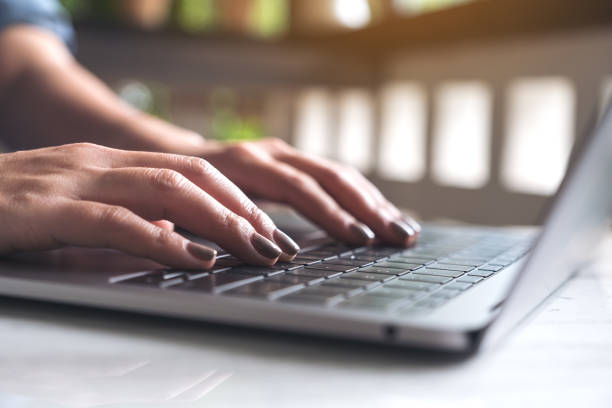 istock Closeup image of a woman's hands working and typing on laptop keyboard on table 988212068